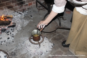 After the caraway seeds have been warmed on the comfit pan by the heat from the brazier, a charge of sugar syrup (heated until it makes a thread between two fingers) is added to the seeds and the caraway comfit making begins.