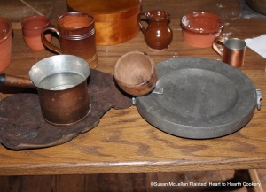 After the macaroni is boiled with the cream, butter and flour for the receipt (recipe) Maccaroni, a water plate needs to be prepared to send it to the table as it soon grows cold.  Pictured is water that has been boiled in the everted saucepan and a wood funnel in the hole of the original pewter water plate.  The hot water keeps the plate warm for service to table.